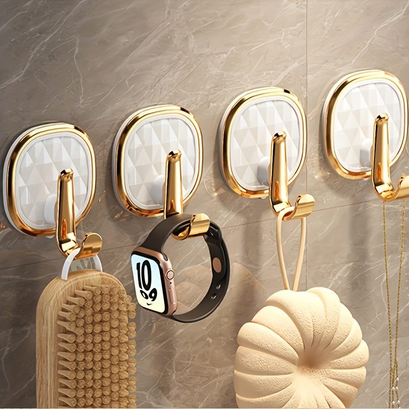 A Stylish Golden Wall-Mounted Hook for Robes And Towels Made of Rust-Resistant Plastic, Featuring a Chic Black Diamond Design. It Has a Strong Adhesive Suitable for Kitchens, Bathrooms, And for Hanging Clothes Or Keys, Utility Hooks